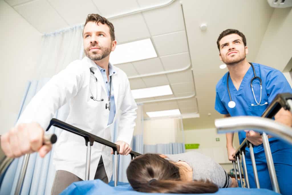 Becoming a Triage NurseTwo doctors moving a critical female patient to an operating room in a stretcher