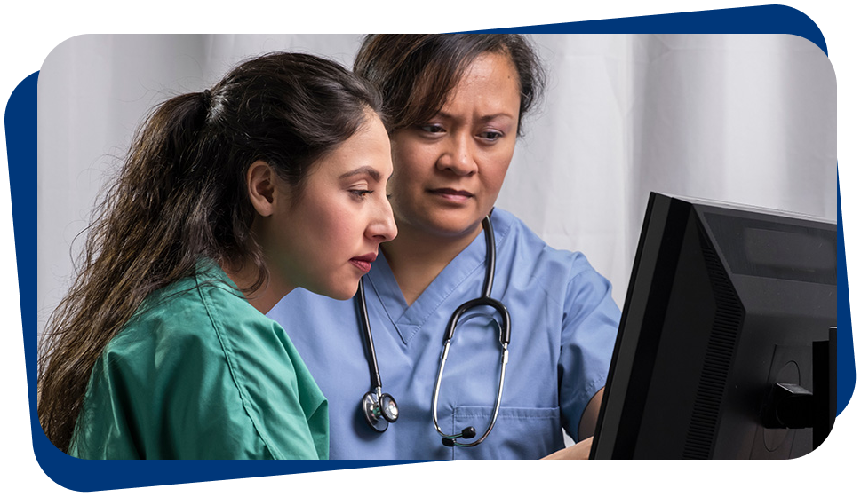 A doctor and nurse looking at a screen, having a discussion.