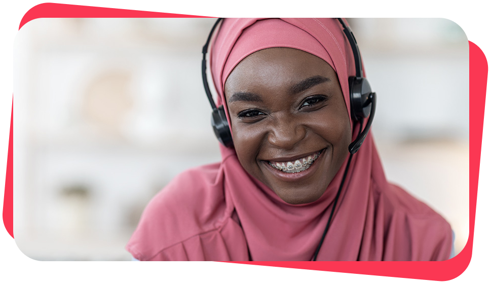 A person with headset taking a call with a smile.